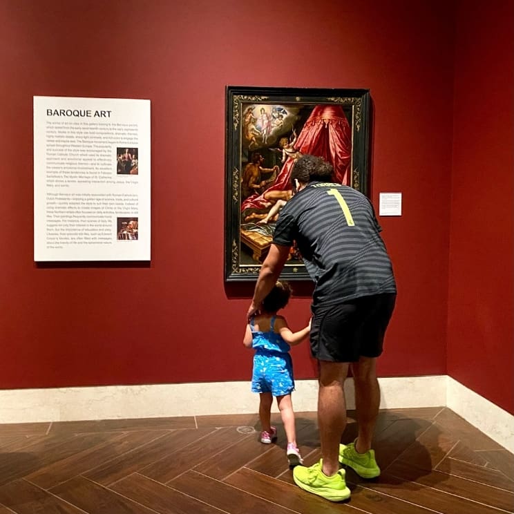 Donate to the MFA St. Petersburg. Image of man with child looking at artwork.