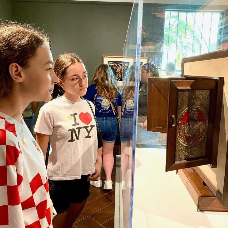 Admission at the MFA. Image: Two girls looking at a cabinet on display in a museum.