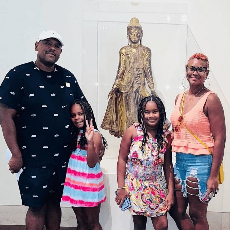 Plan your visit to the MFA. Image of family in front of Asian Art sculpture.