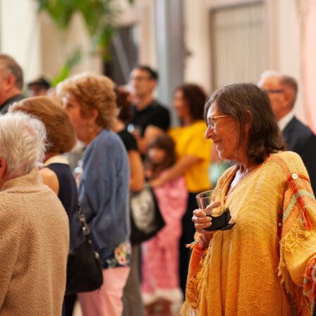 Member-exclusive programs at the MFA. Image of woman smiling in a crowd of people.