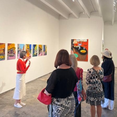 MFA Collectors Circle - affinity group for collectors and connoisseurs of art. Image of people looking at bright paintings in an art gallery